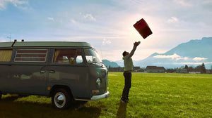 AEROSTUFFY Box L rot hochgeworfen in die Luft neben einem VW T2 Westfalia